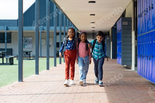 Preview: Biracial boy and girls walk together in a school corridor