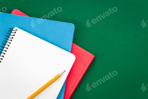 Preview: Notebooks on green background, school concept, flat lay.