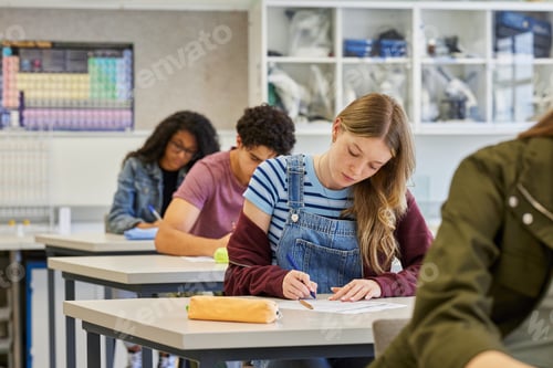 Preview: Secondary students taking test sitting in a line