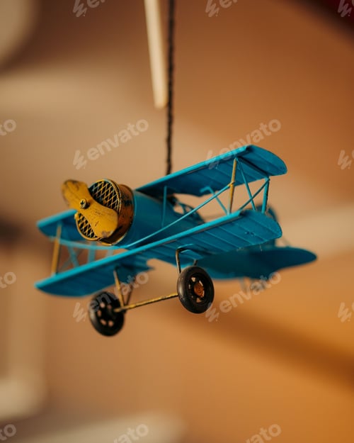 Preview: Blue toy airplane hangs from the ceiling.