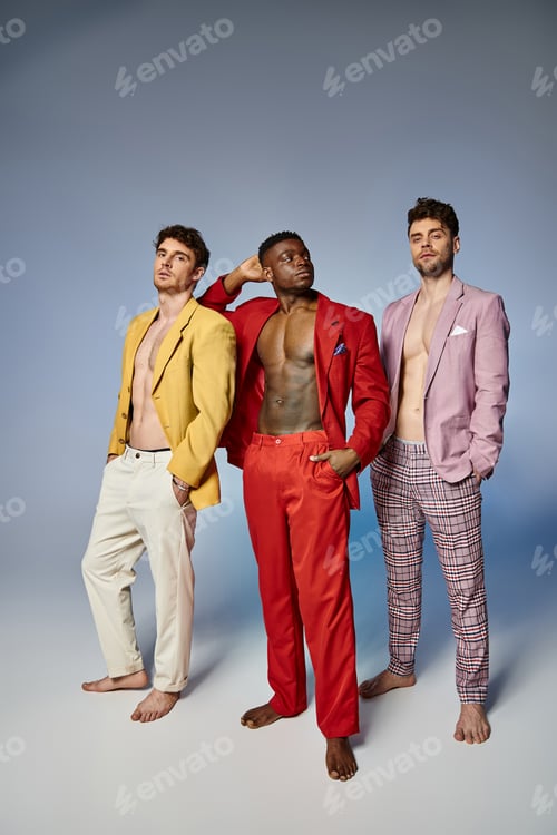 Preview: attractive multiracial friends in unbuttoned bright suits on gray background, fashion concept