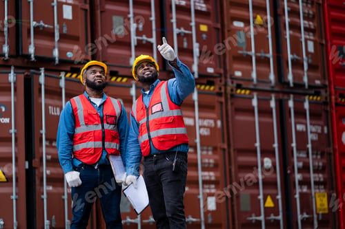 Preview: Engineers oversee the loading of containers from cargo ships.