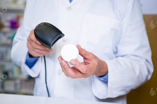 Preview: Pharmacist using barcode scanner on medicine container