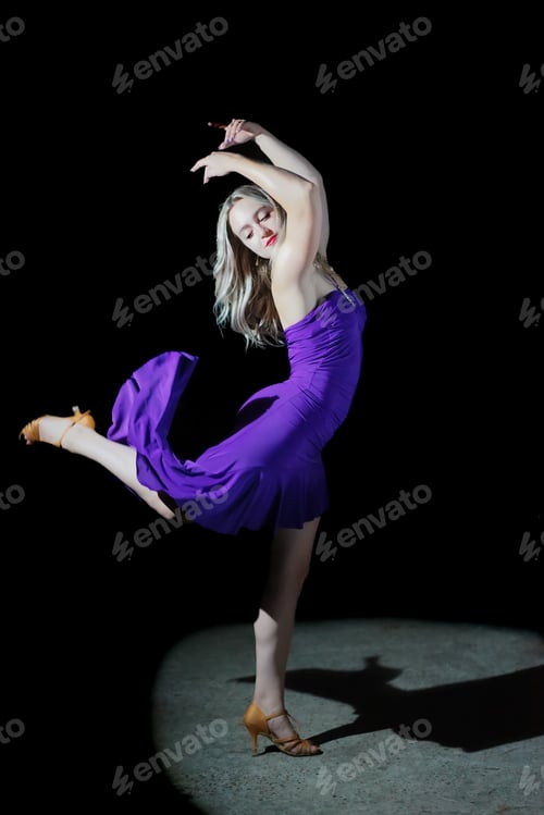 Preview: beautiful dancer in stylish dress with fringe performing tango on black background