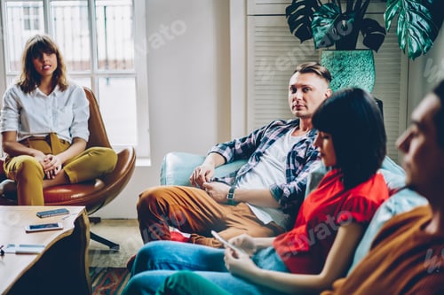 Preview: Trendy millennial students relaxing together in light contemporary lobby