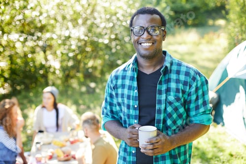 Smiling Man Enjoying Camping with Friends
