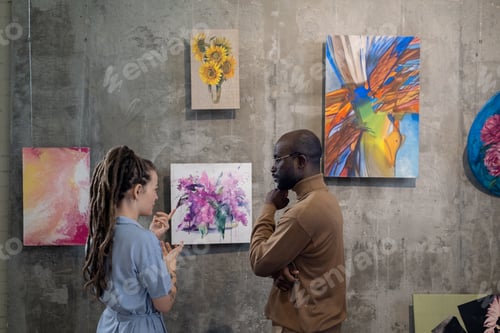 Preview: Couple discussing modern art in studio