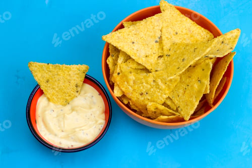 Preview: mexican corn chips nachos with sauce on blue background top view