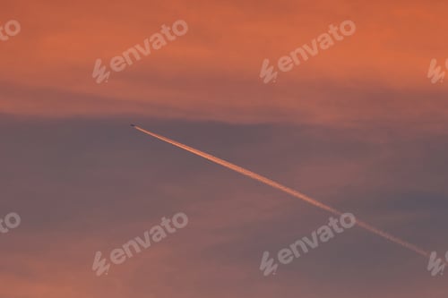 Preview: Pink Clouds And Contrail At Sunset - Photograph Of Pink Sunset Clouds In A Blue Sky With A Jet