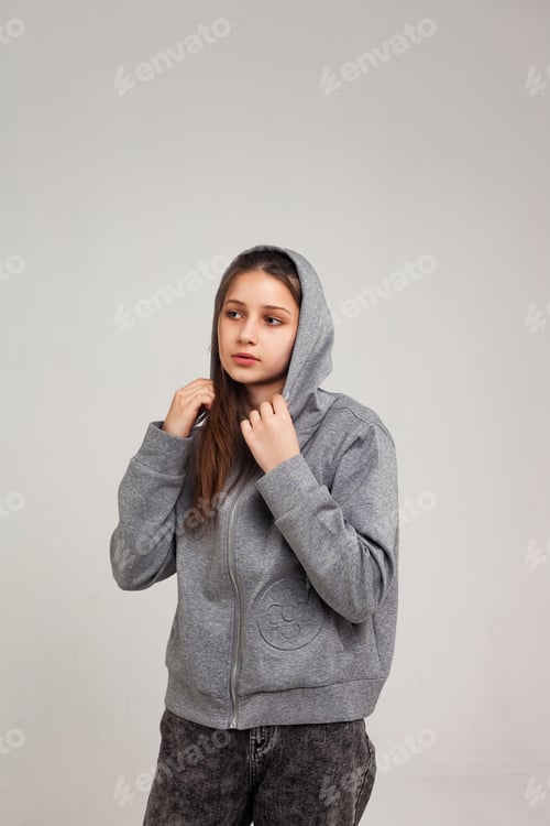 Preview: Youthful Spirit in a Cozy Grey Hoodie Standing With a Gentle, Curious Gaze