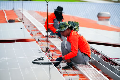 Preview: Engineer service check installation solar cell on the roof of factory.