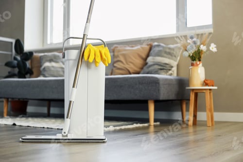 Preview: Cleaning supplies: mop, gloves, bucket with wringer on wooden laminate floor
