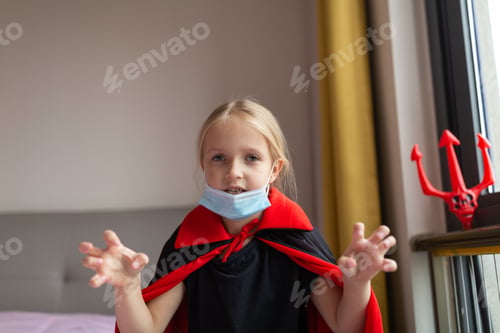 Preview: Portrait of cute Little Girl in costume of evil at home. Happy Halloween during coronavirus covid-19