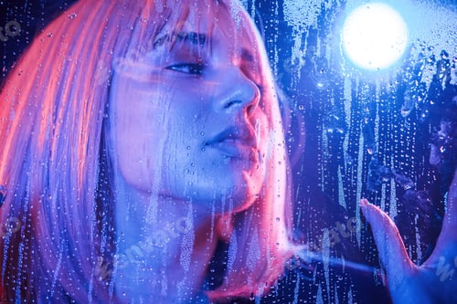 Preview: calm facial expression. Stylish woman with white hair is behind wet transparent plastic sheet