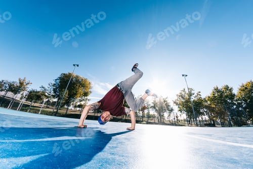 Preview: Young man break dancing at basketball court