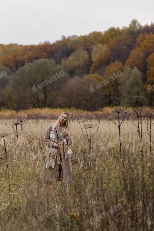 Preview: young woman enjoying autumn nature