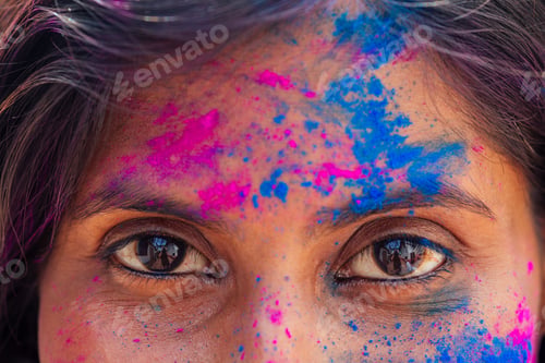Preview: Holi Festival Of Colours. cropped portrait of happy indian girl in holi color. eyes close up