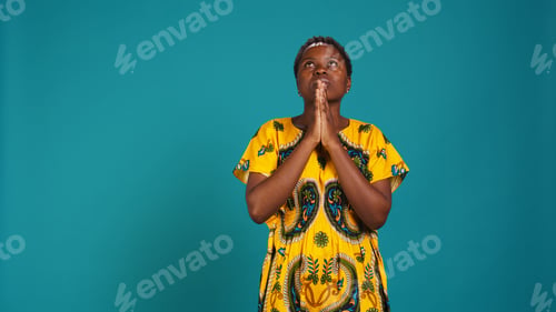 Preview: Spiritual hopeful woman holding hands in a prayer and having belief in Jesus