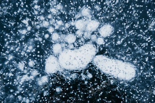 Preview: Blue textured ice background. Frozen Lake Baikal with bubbles and cracks. Baikal ice patterns.