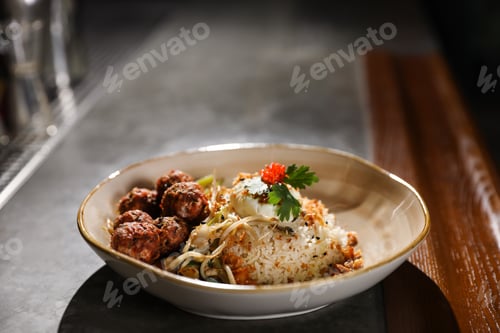 Preview: Plate with rice and meat balls served on table