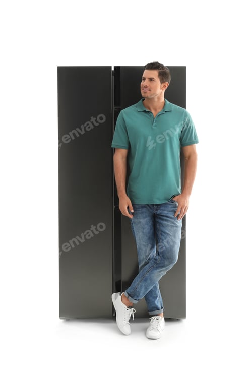 Preview: Happy man near refrigerator on white background