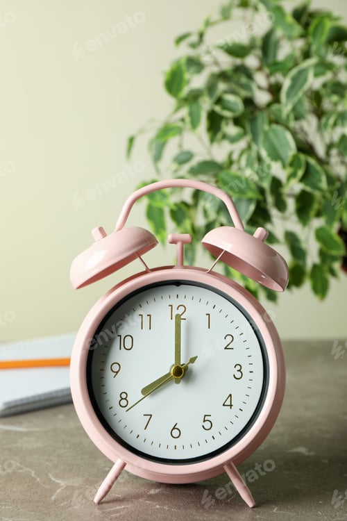 Preview: Education concept with alarm clock on gray textured table