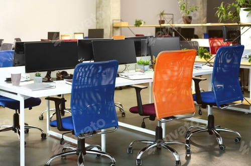 Preview: Creative interior of cozy co-working space with computers