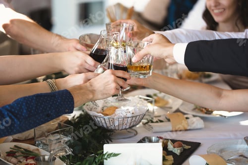 Preview: Celebration, eating and holidays concept - hands clinking wine glasses
