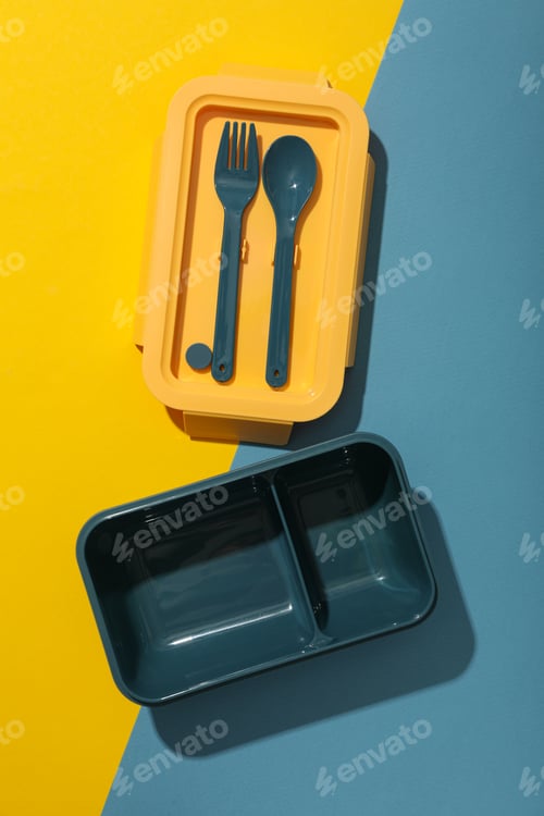Preview: A blue lunchbox with a yellow lid and blue forks