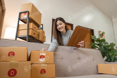 Preview: woman sell products online Small Business , Young Asian women happy after a new order from the
