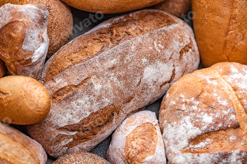 Preview: Freshly baked natural bread is on the kitchen table.
