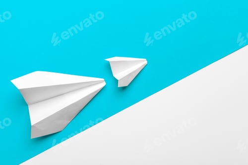 Preview: paper airplanes on pastel colored background. childhood,freedom and diversity concept