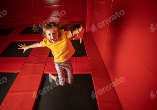 Preview: Little girl jumping on trampoline in fly park