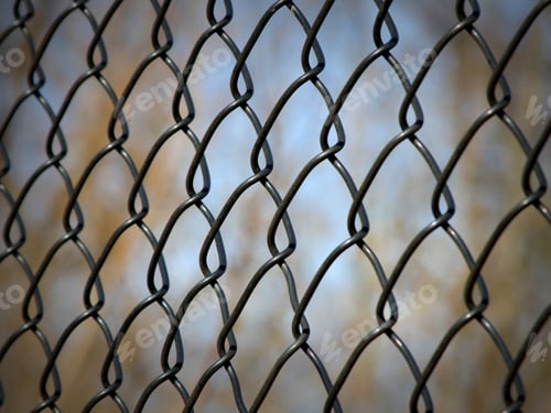 Preview: Chain Link Fence With Blurred Trees And Sky Background - Photograph Of A Chain Link Fence With A