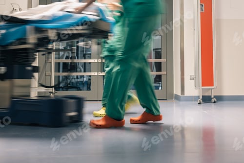 Preview: Surgeons in Motion, legs and feet of surgeons in green scrubs and colorful shoes