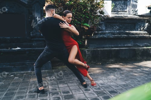 Preview: Young couple dancing gracefully on pavement