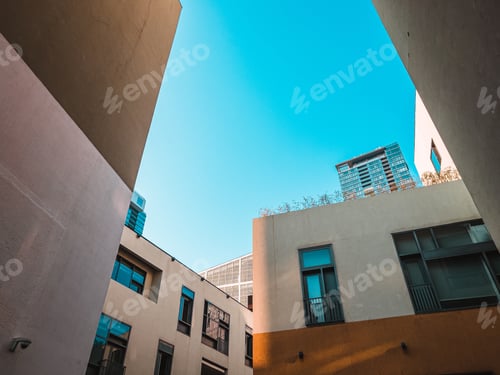 Preview: Low angle shot of modern buildings on a blue sky background