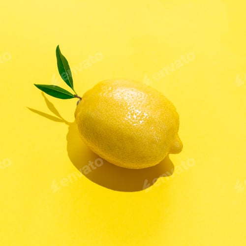 Preview: Whole lemon with leaves on yellow background, hard shadows, square format, top view