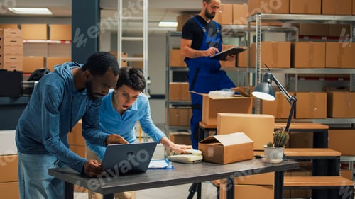 Preview: Young entrepreneurs doing teamwork to ship products in cardboard packages