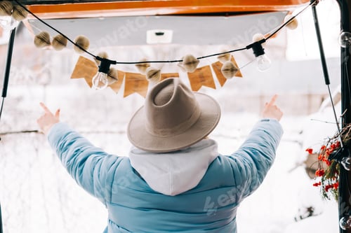 Preview: Woman with Hat Celebrates Winter from Orange Vehicle