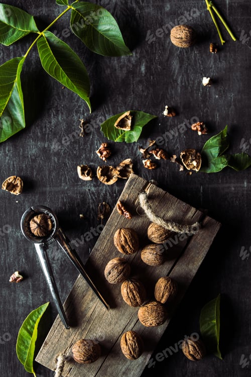 Preview: Walnuts on dark vintage table. healthy food. Old vintage table and leaves from the nut