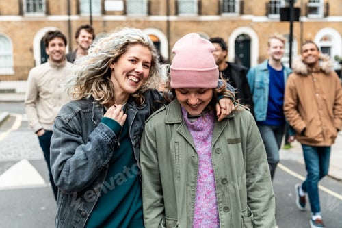 Preview: Multicultural group of friends walking and having fun together in London