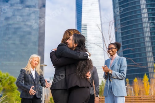 Preview: Middle-aged multiethnic businessmen and businesswomen, coworkers hugging, good work environment