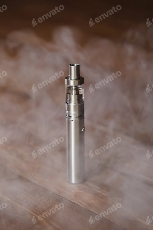 Preview: Electronic cigarette on a wooden table. Smoke