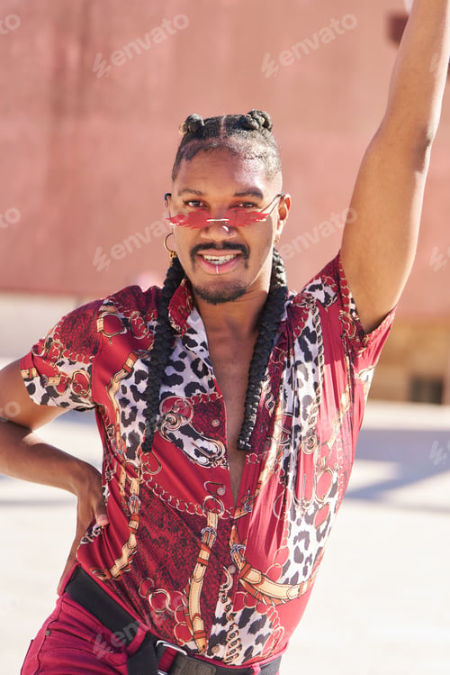 Preview: A man wearing a red shirt with leopard print poses for a photo
