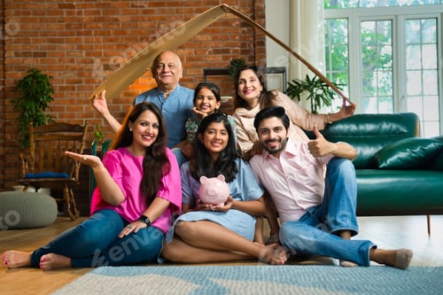 Preview: Multigenerational Indian family of six holding a cardboard roof and piggy bank, real estate savings
