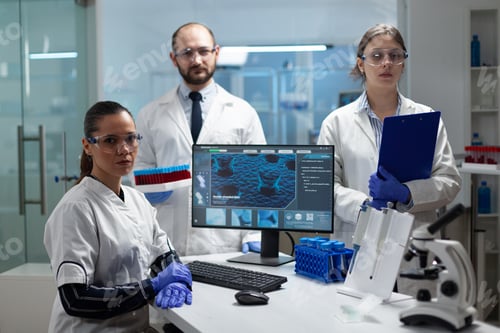Preview: Portrait of medical scientist team working in microbiology hospital laboratory
