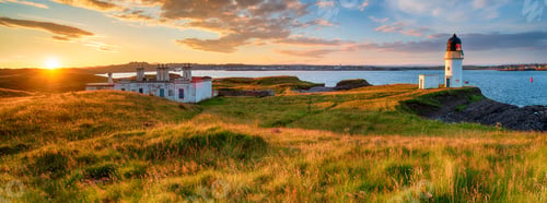 Preview: Panoramic view of sunset over the lighthouse and coastguard cottages at Arnish Point