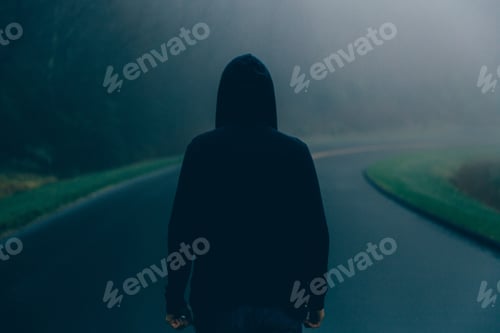 Preview: Man on a mountain road observing the foggy nature.