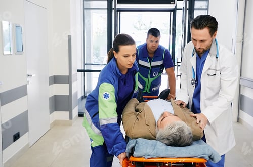 Preview: Paramedics and doctor rushing with victim patient on ambulance stretcher on hospital corridor at